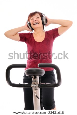 Senior woman with headphones listening music on bicycle