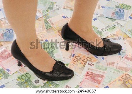 Legs in elegant shoes on euro banknotes (money under control and security concepts)