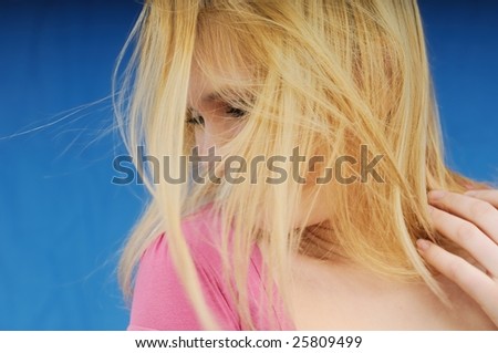 Blond woman hiding face - head turned away