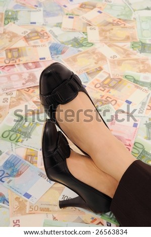 Crossed legs on banknotes (money under control and security concepts)