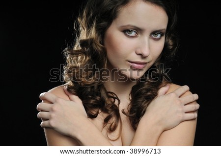 stock photo Young beautiful nude woman protecting herself holding
