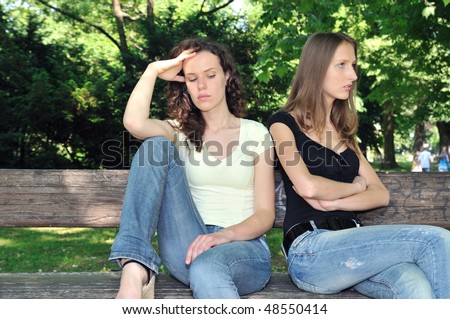 Friends outdoors series - two teenage girls are angry due to ther conflict