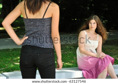 Modern woman (torso visible only) looking at another one with innocent look