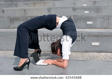 stock photo Flexible business woman with laptob