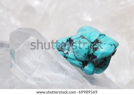 Turquoise gem energized on druze of quartz crystals. This gem is used as a jewel stone and also in alternative medicine and esoterics.