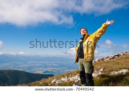 Woman enjoys sun in mountains on hiking