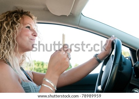 Young woman eating sweets while driving car