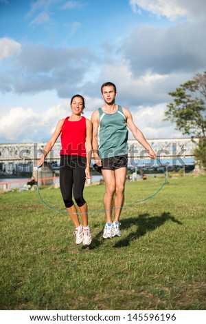 Young sport couple in starting position prepared to compete and run
