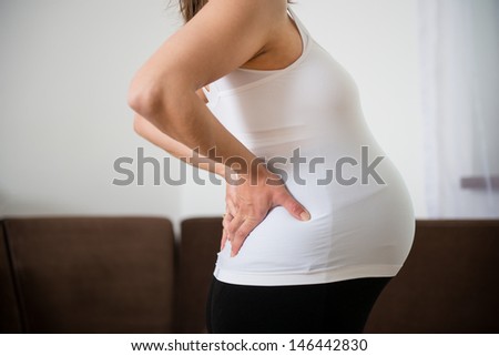 Torso Of Pregnant Woman With Backache - Holding Back