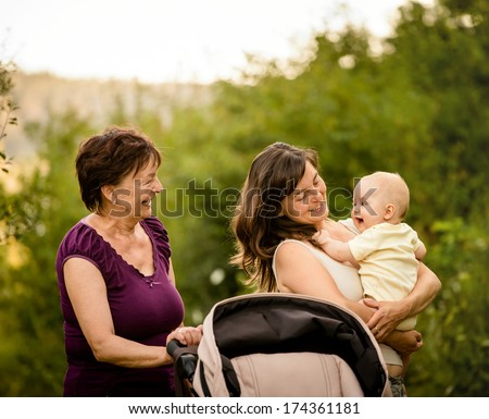 Happy together - grandmother with her daughter and her granddaughter outdoor in nature