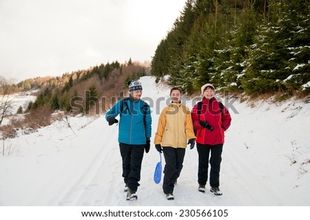 Family in winter together walking in snow