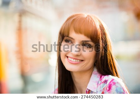 Portrait of beautiful smiling woman looking away with flare reflections