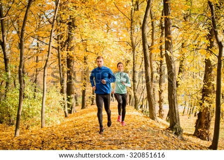 Jogging couple - young man and woman competing, man first