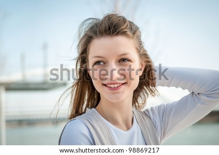 Outdoor portrait of young beautiful woman - hand in hair