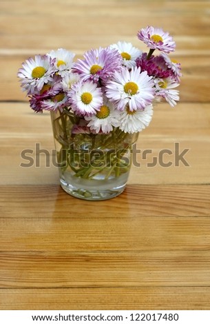 Bouquet of daisies on a vintage wooden surface