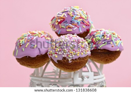 Cake pops - a form of cake styled as a lollipop, invented in USA. Typical dessert of american parties, lavishly embellished.