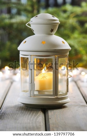 White lantern on wooden rustic table.