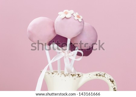 Pink cake pops in ceramic vase
