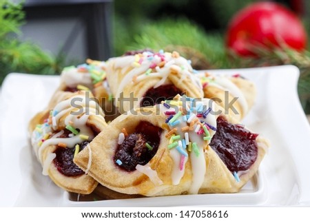 Christmas cookies filled with marmalade, decorated with colorful sprinkles