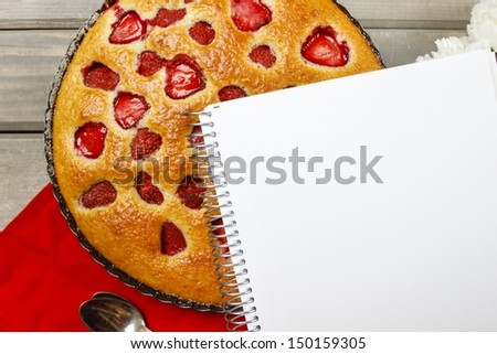 Top view of blank sheet of paper and round strawberry pie. Blank space for recipe, selective focus
