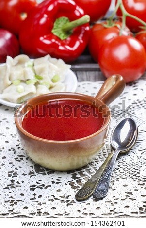 Traditional polish dinner, borscht and dumplings, on wooden table. Selective focus