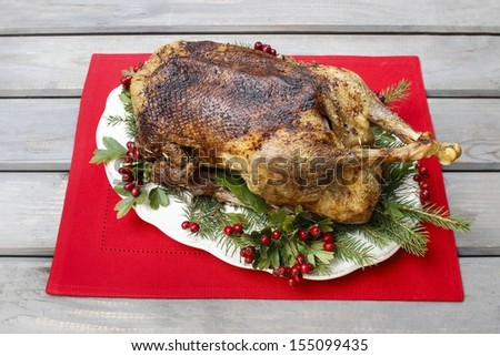 Baked goose on wooden table. Popular christmas dish