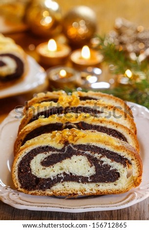 Poppy seed cake in golden christmas setting. Selective focus