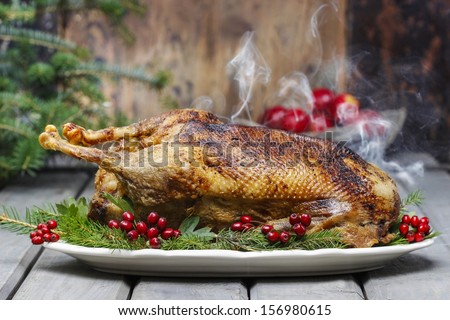 Baked Goose On Wooden Table. Popular Christmas Dish