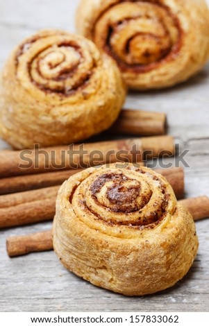 Cinnamon rolls on rustic rough wooden table