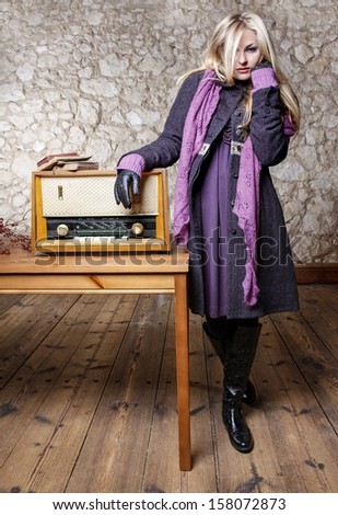Elegant beautiful woman with book and vintage radio in country house