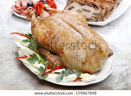Baked duck on wooden table. Popular christmas dish