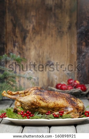 Baked Goose On Wooden Table. Popular Christmas Dish