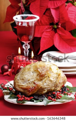Baked pork with dried plums on christmas table