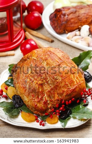 Baked pork with dried apricots on christmas table