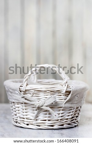 Empty wicker basket isolated on wooden background