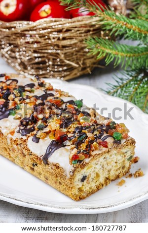 Fruitcake with dried fruits and nuts in christmas setting
