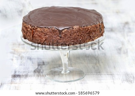 Chocolate cake on wooden background. Copy space