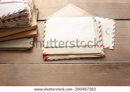 Stack of vintage letters on wooden table, copy space