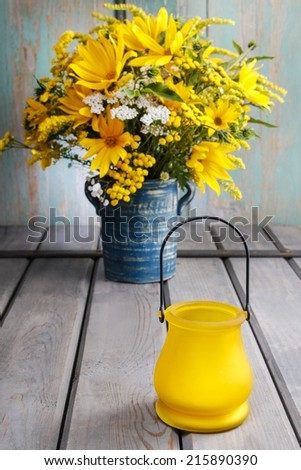 Bouquet of sunflowers and wild flowers on wooden table