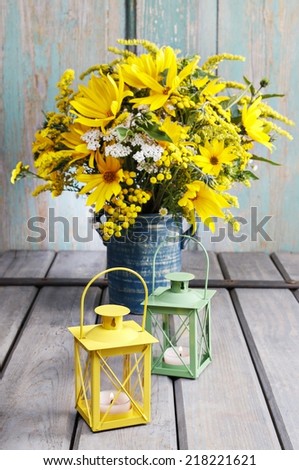 Bouquet of sunflowers and wild flowers on wooden table