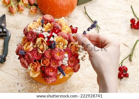 How to make a Thanksgiving centerpiece - step by step: arrange flowers into the pumpkin
