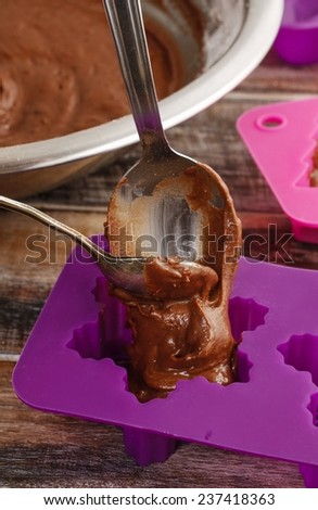 Steps of making chocolate cake: filling silicone mold with pastry