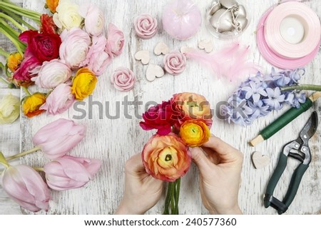 Florist at work. Woman making bouquet of persian buttercup flowers (ranunculus)