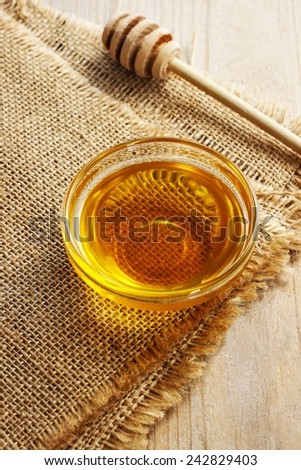 Bowl of honey on wooden table. Symbol of healthy living and natural medicine. Aromatic and tasty.
