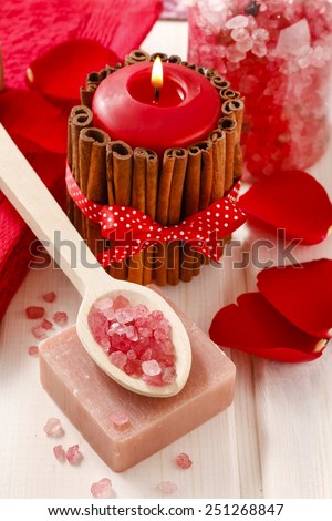 Spa set: scented candle, sea salt, bar of soap and romantic red rose petals