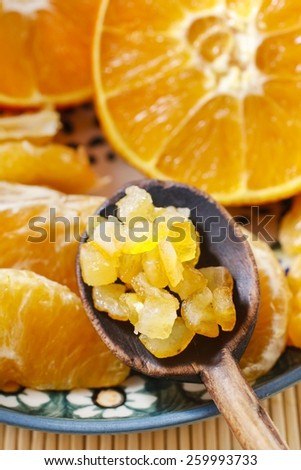 Candied orange peel and fresh juicy oranges