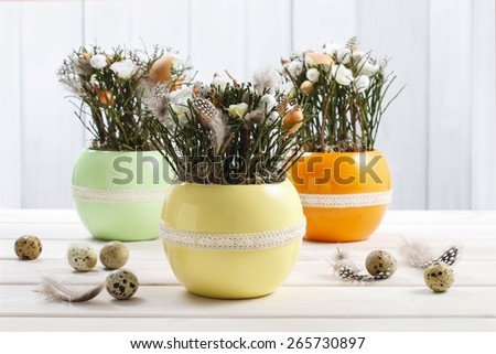 Easter table decoration with twigs, feathers and flowers