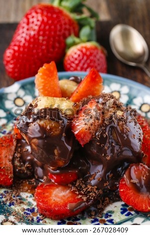 Profiteroles with strawberries and chocolate sauce