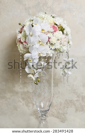 Floral arrangement with white orchids, carnations and chrysanthemums.