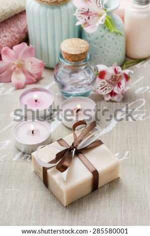 Bar of handmade soap and spa cosmetics in the background